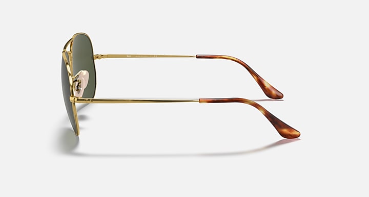 Gold aviator metal sunglasses side view with dark green lenses and brown temple tips