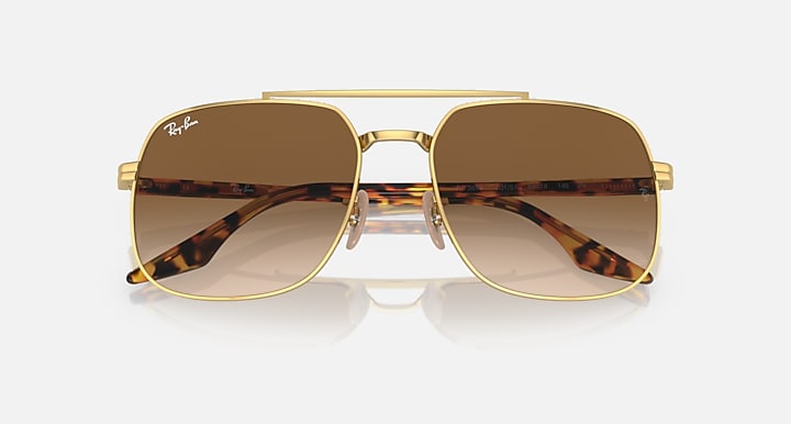 Gold frame square sunglasses with dark brown lenses and tortoise arm detail