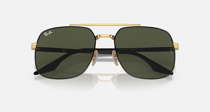 Gold-frame square sunglasses with dark green lenses and mirrored-style glare