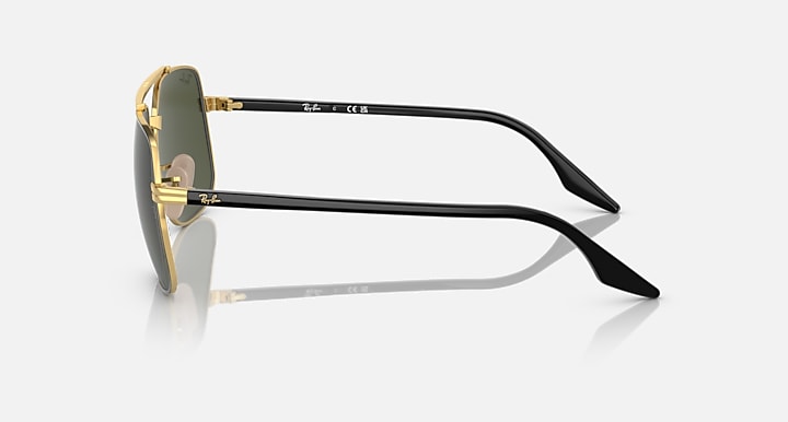 Square sunglasses side view with black arms and gold hinge hardware; dark green lens