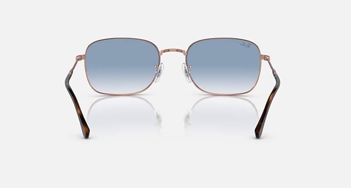 Rectangular sunglasses, rose-gold frame, blue gradient lenses with dark upper tint