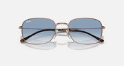 Rectangular sunglasses, rose-gold frame, dark gradient lenses with lighter lower tint