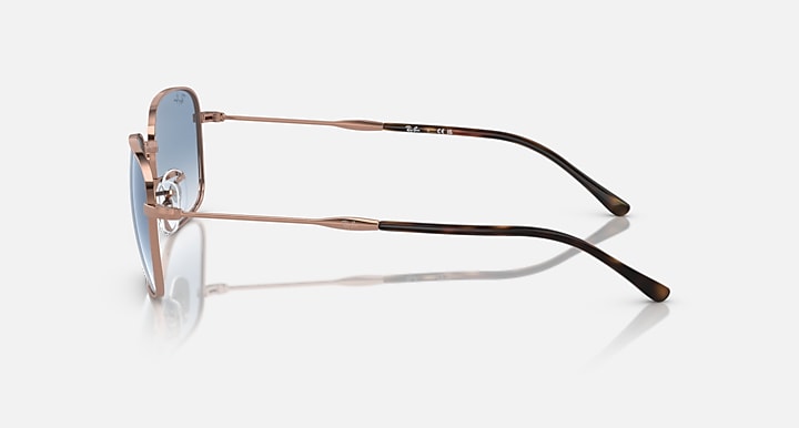 Rectangular sunglasses side view, rose-gold metal frame, black striped temple arms