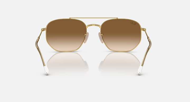 Gold-tone sunglasses with brown gradient lenses and metal bridge