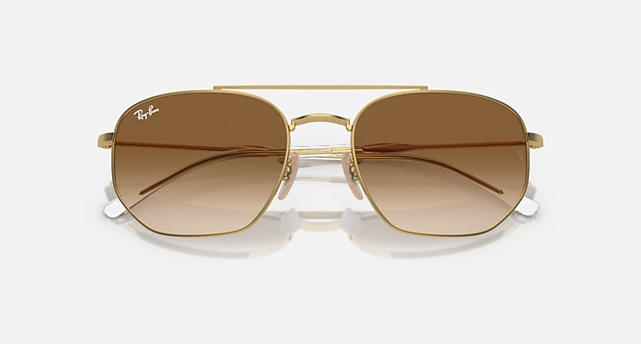 Gold-tone sunglasses with warm brown lenses and curved metal frame
