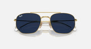 Gold sunglasses with dark blue lenses and rounded rectangular shape.