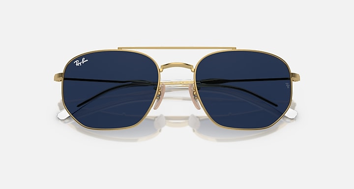 Gold sunglasses with dark blue lenses and rounded rectangular shape.