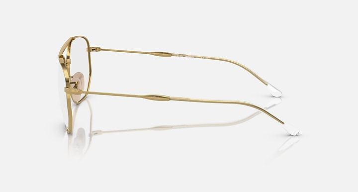 Side view of gold metal sunglasses with clear lenses.