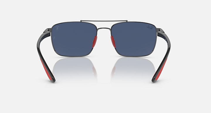 Sunglasses front view with dark blue mirrored lenses, gunmetal frame and red temple tips