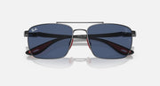 Sunglasses front with dark blue lenses and gunmetal frame, red inner temple accents