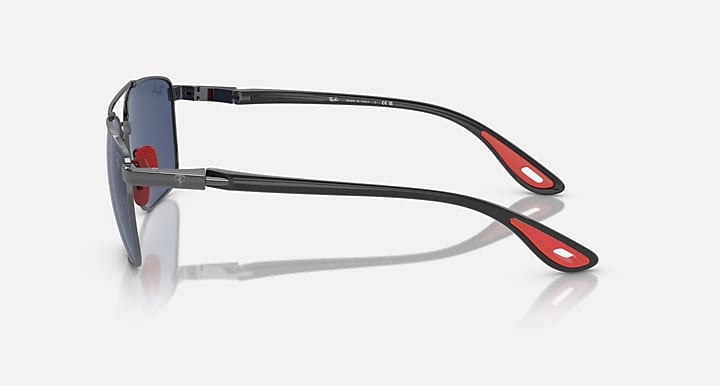 Sunglasses side profile with dark blue lenses, gunmetal frame, red stripe on temple