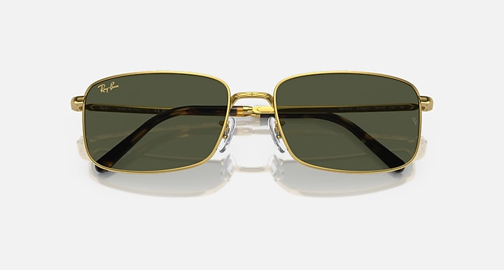 Gold-framed square sunglasses with dark lenses and metal bridge detail