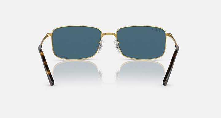 Gold-framed square sunglasses with blue-tinted lenses and thick black temple arms