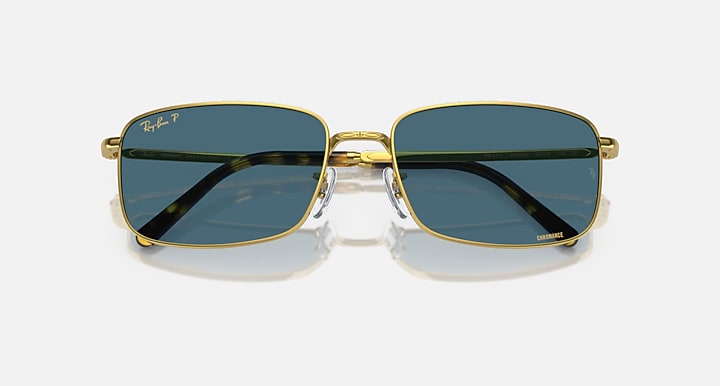 Gold-framed square sunglasses with dark blue lenses and metal bridge detail