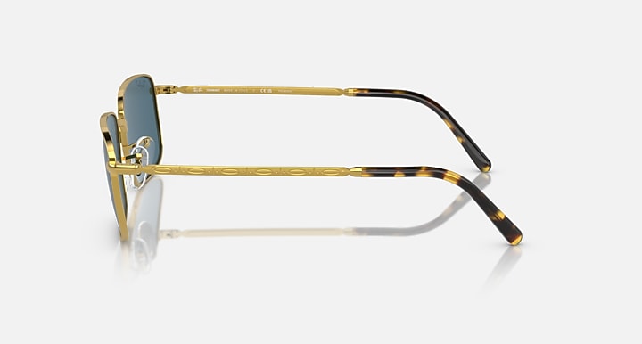 Gold and black temple sunglasses with blue-tinted lenses, side profile