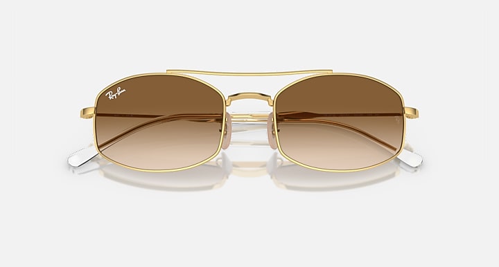 Ray-Ban square sunglasses with gold frame and amber gradient lenses, slight angled view