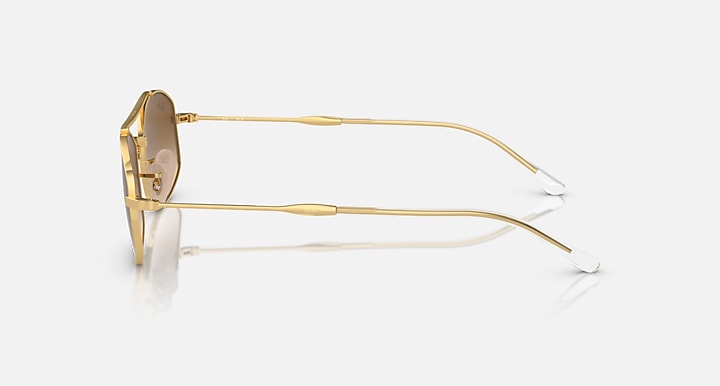 Ray-Ban sunglasses with gold metal frame and clear lenses, side view