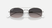 Ray-Ban sunglasses with dark gradient lenses and clear frame with silver accents