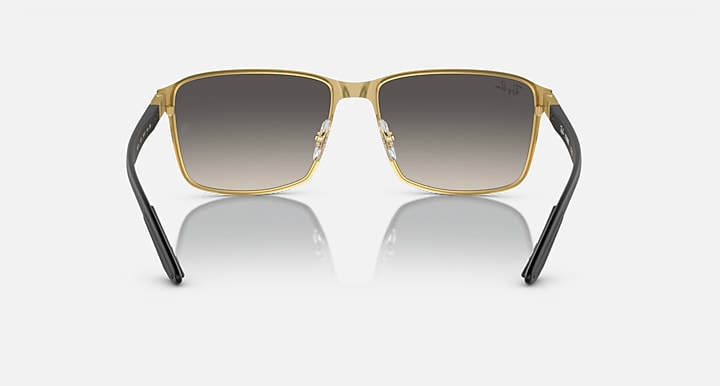 Square sunglasses with gold-tone frame and dark brown gradient tinted lenses