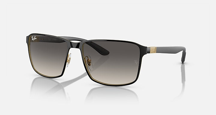 Square sunglasses with black frame, gold accents, and dark grey gradient lenses