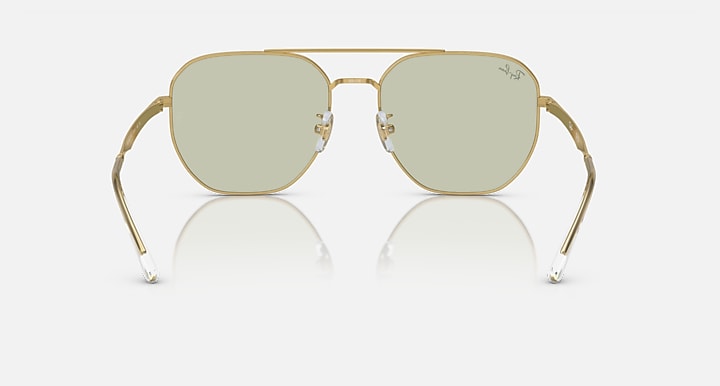 Gold aviator sunglasses with light green tinted lenses and curved metal nose bridge