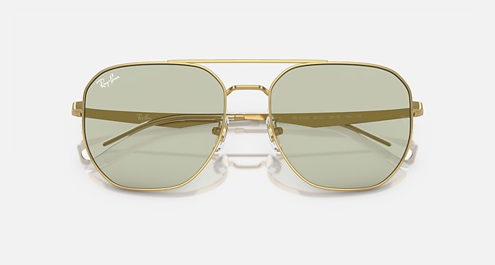 Gold aviator sunglasses with light green tinted lenses and dark-tinted upper band