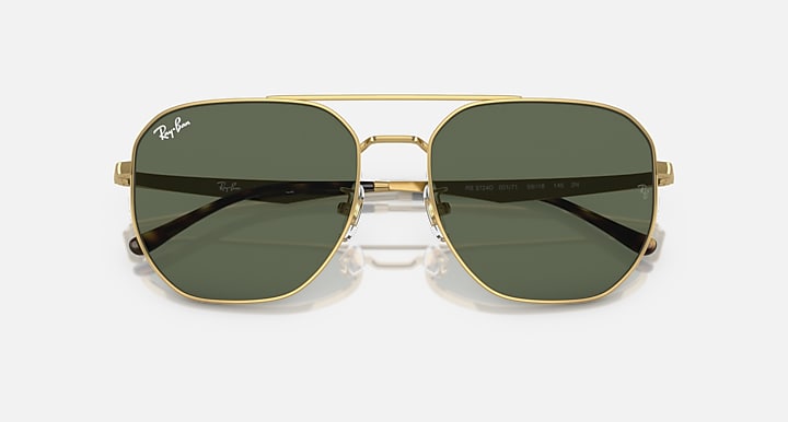 Gold aviator sunglasses with dark green tinted lenses and metal bridge