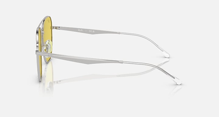 Ray-Ban aviator sunglasses with yellow-tinted lenses and silver-tone frame, side profile