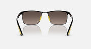 Black sunglasses with dark lenses, yellow accents, and visible metal hinges