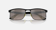 Black rectangular sunglasses with dark lenses and yellow hinge accents