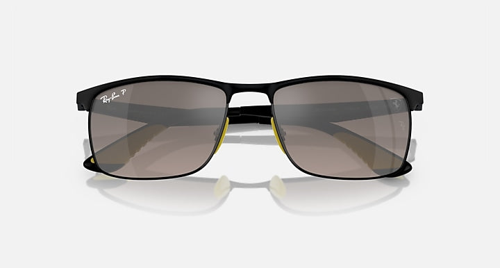Black rectangular sunglasses with dark lenses and yellow hinge accents