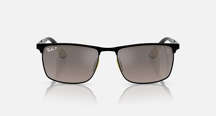 Black square sunglasses with dark lenses and yellow accents on temples