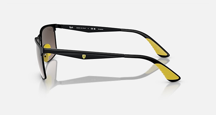 Black sunglasses side view with dark lenses and yellow temple tips