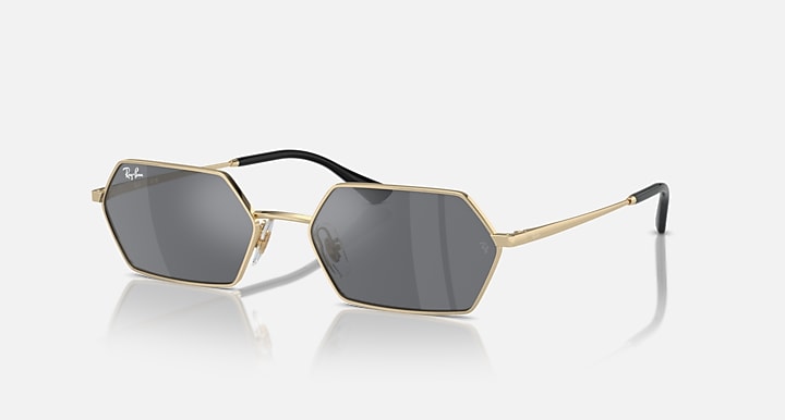 Hexagonal dark mirrored sunglasses with light gold frame and black temples