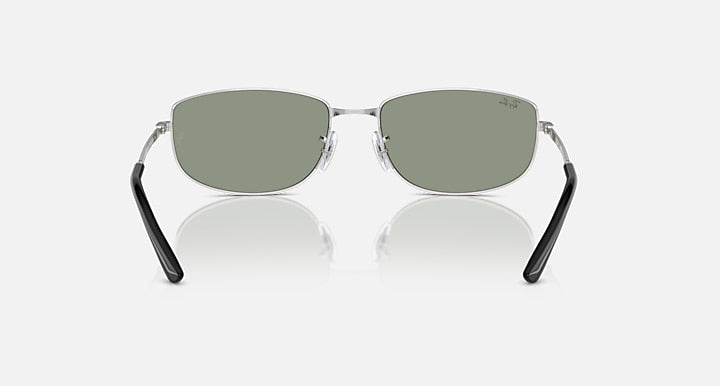 Silver sunglasses with olive-green lenses and black temple ends