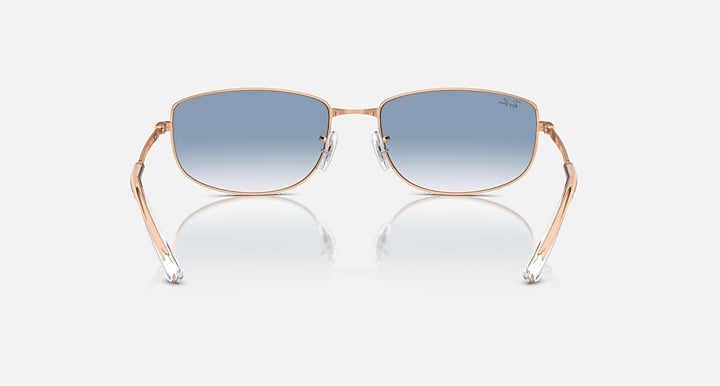 Rose gold sunglasses with blue mirrored lenses and metal bridge detail