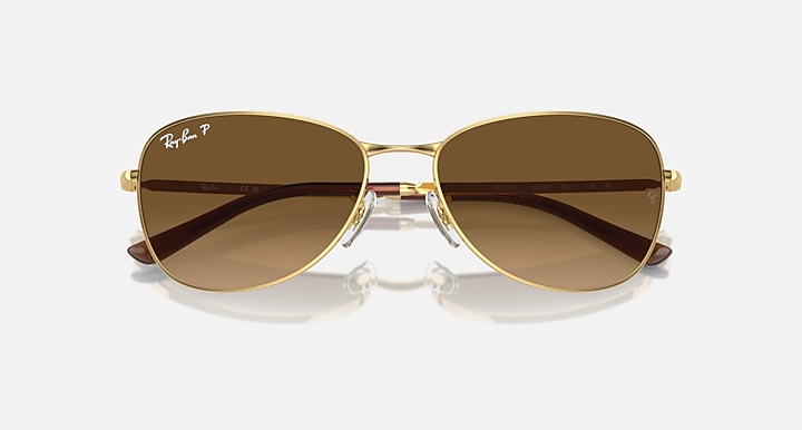 Gold-tone aviator sunglasses with dark brown gradient lenses and brown temples
