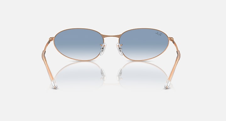 Gold-tone oval sunglasses with blue gradient lenses and metal bridge