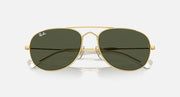 Gold oval sunglasses with dark green lenses and mirrored reflection on glass