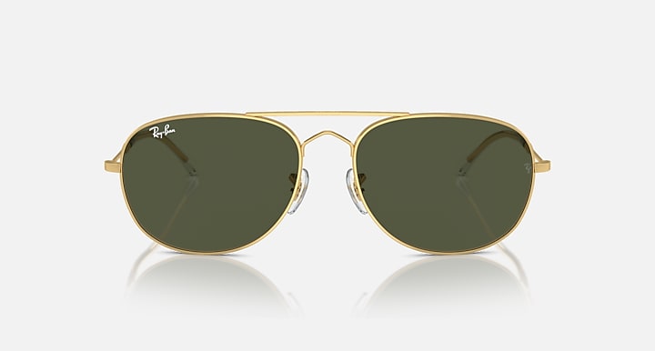 Gold oval sunglasses with dark green lenses and slim keyhole bridge