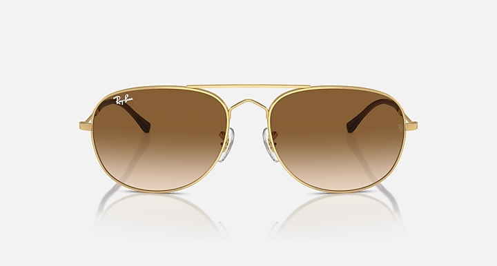 Gold oval sunglasses with brown gradient lenses and slim keyhole bridge