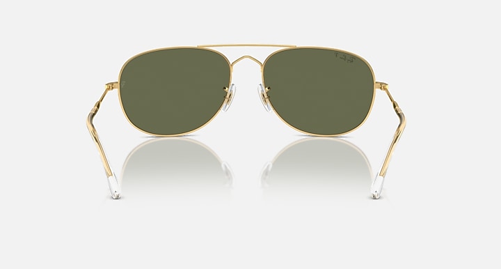Gold aviator sunglasses with dark green lenses and transparent nose bridge