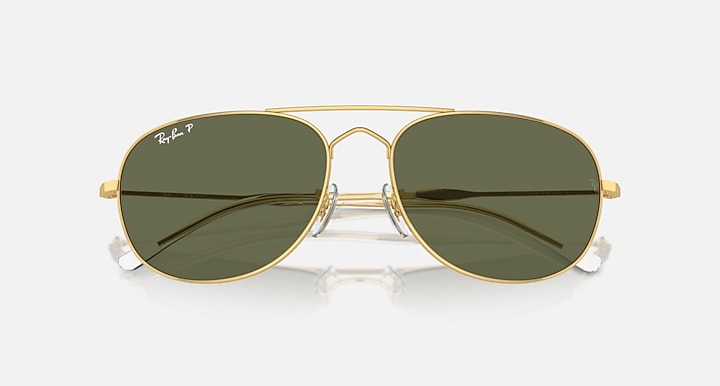 Gold aviator sunglasses with dark green lenses and slim gold metal frame