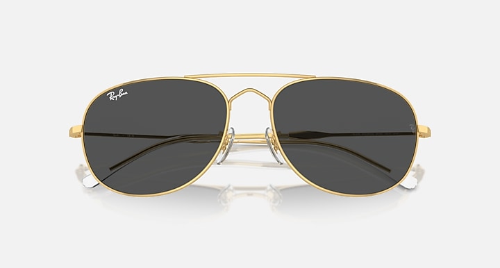 Gold aviator sunglasses with dark gray mirrored lenses and thin metal bridge