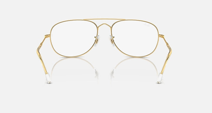 Gold aviator sunglasses with clear lenses and gold metal frame
