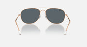 Ray-Ban aviator-style sunglasses with rose-gold frame and dark gradient lenses
