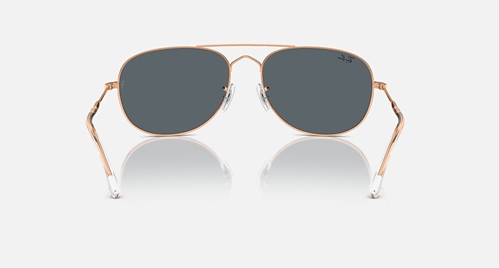 Ray-Ban aviator-style sunglasses with rose-gold frame and dark gradient lenses