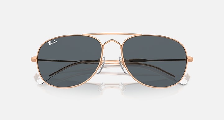 Ray-Ban aviator-style sunglasses with rose-gold frame and dark tinted lenses