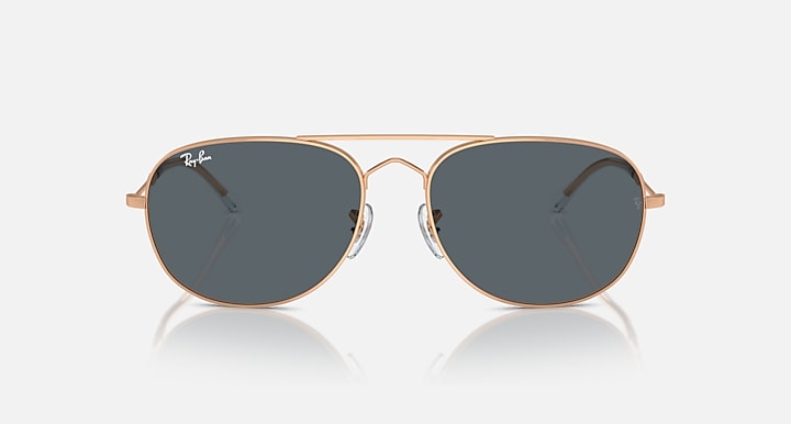 Ray-Ban aviator-style sunglasses with rose-gold frame and dark smoke lenses