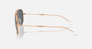 Ray-Ban aviator-style sunglasses side view with rose-gold frame and dark lenses